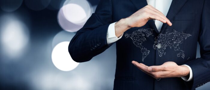 businessman holding world map in hands